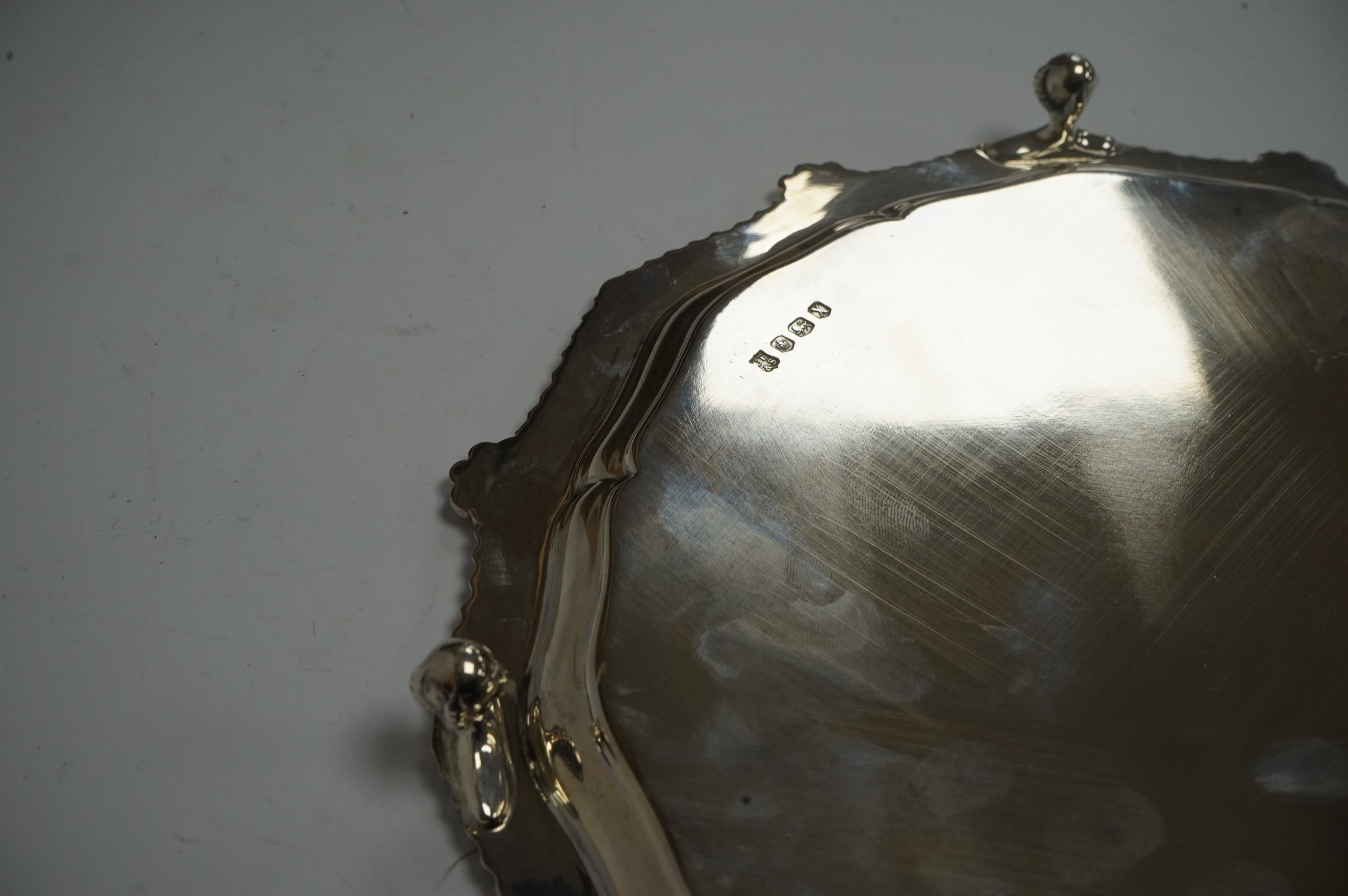 An Elizabeth II silver salver, of shaped circular form, with gadrooned border, on four claw and ball feet, Cooper Brothers & Sons, Sheffield, 1965, 26.8cm, 23.6oz. Condition - fair